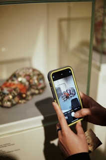 a person holding a cell phone in their hand