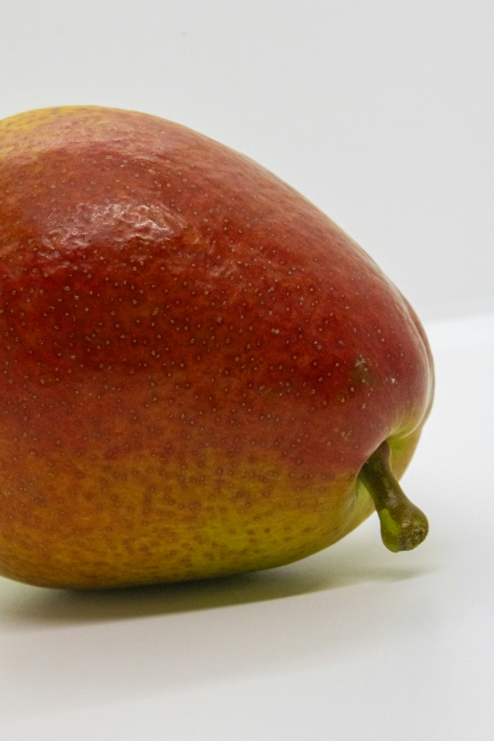 a close up of a fruit on a white surface