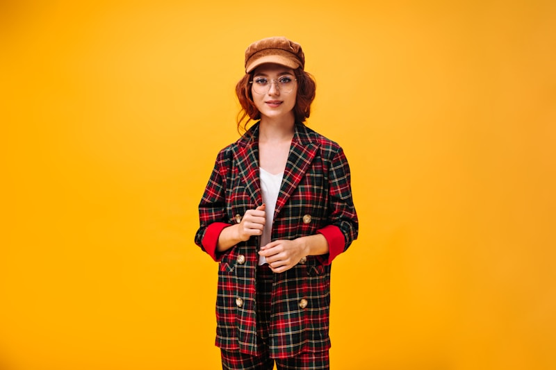 Stylish woman in checked coat and hat