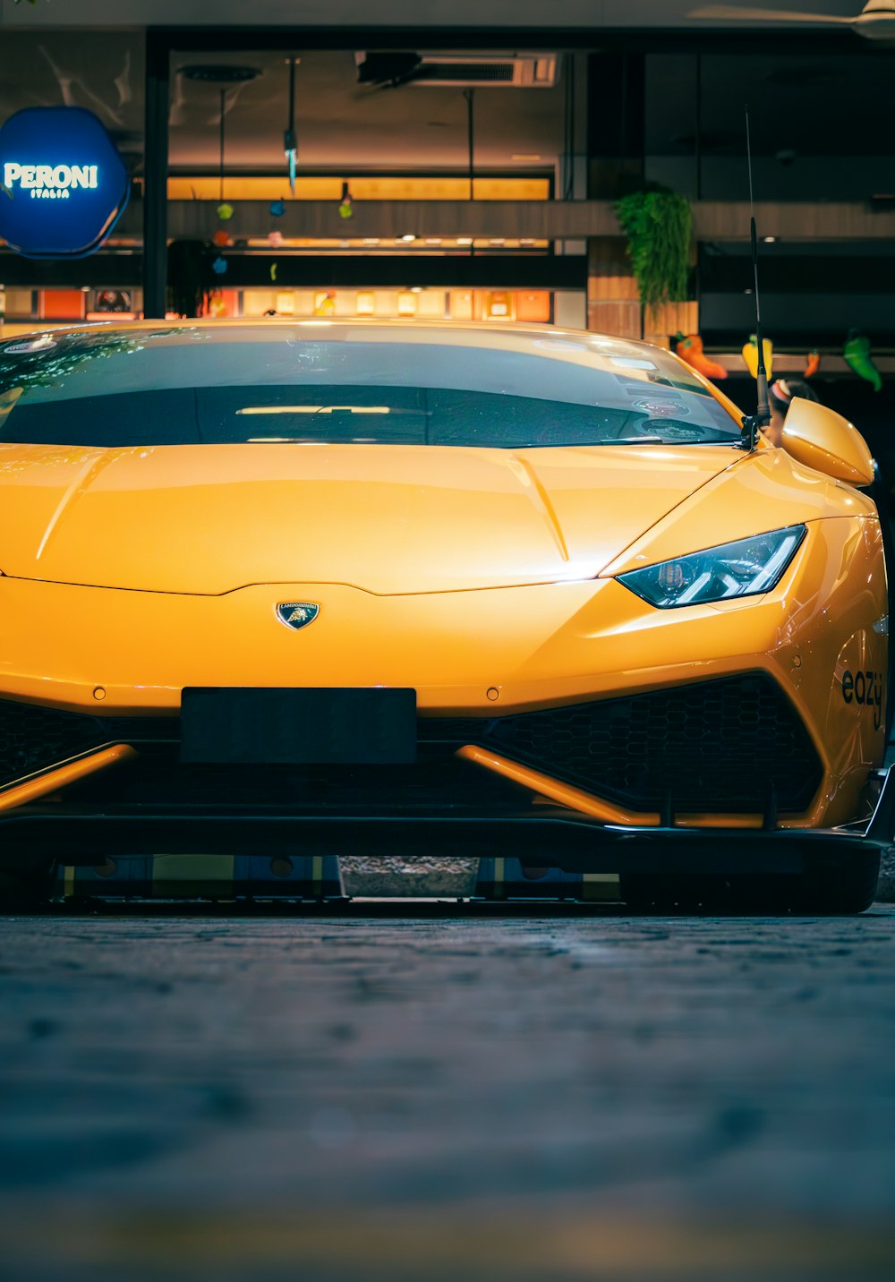 a yellow sports car parked in front of a building