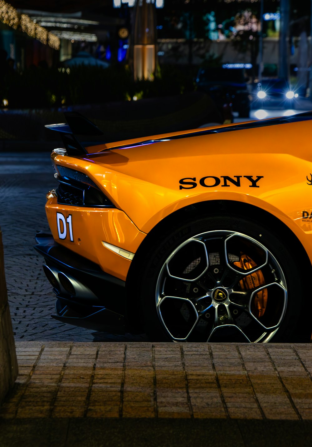 a yellow sports car parked on the side of the road