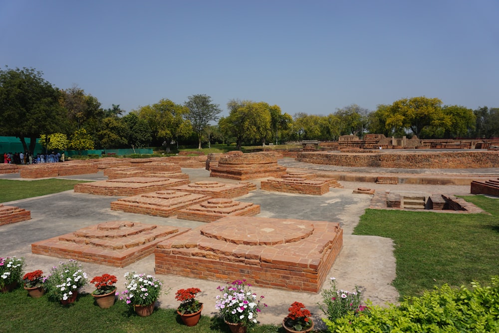 a group of bricks sitting on top of a lush green field