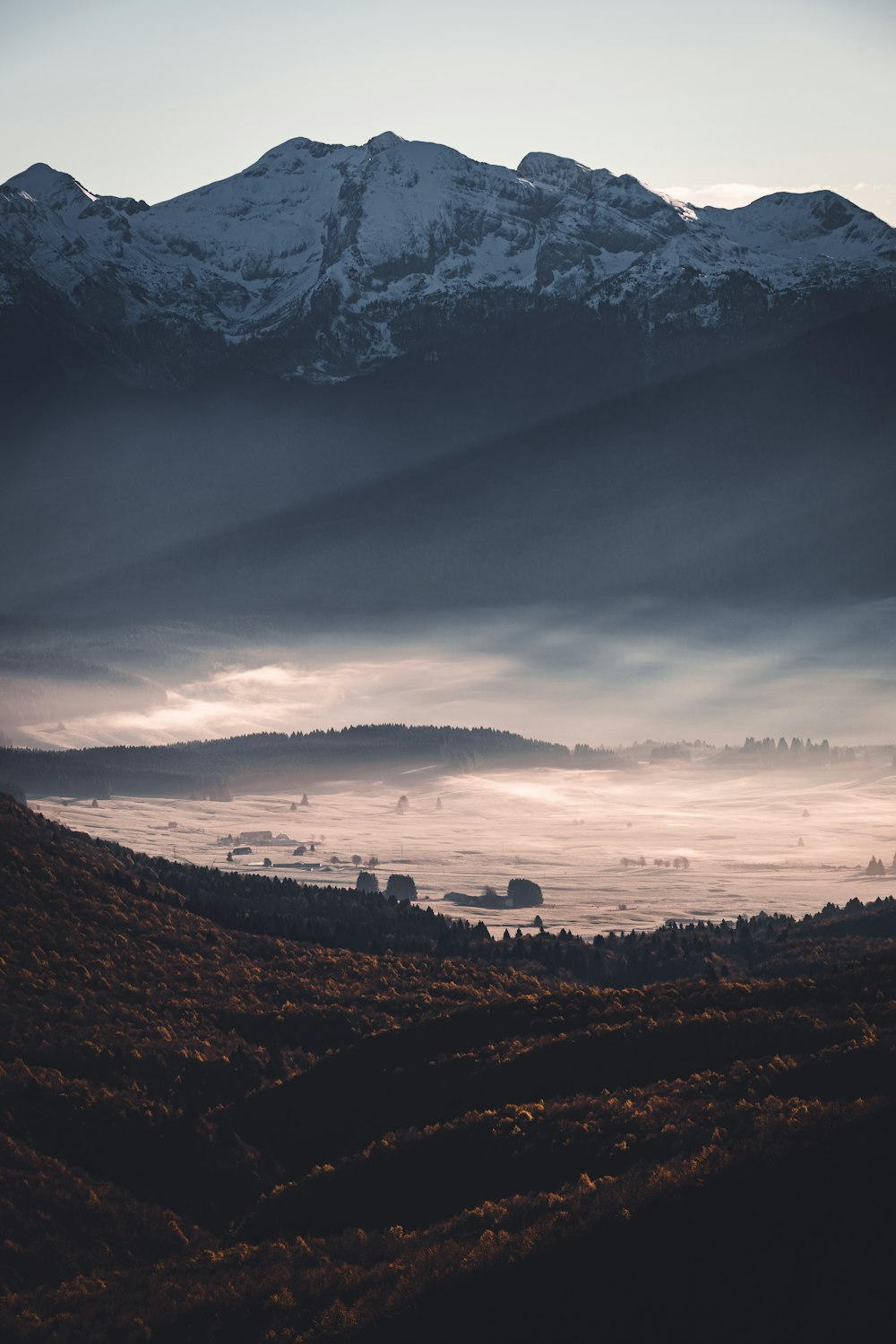 a view of a mountain range covered in fog