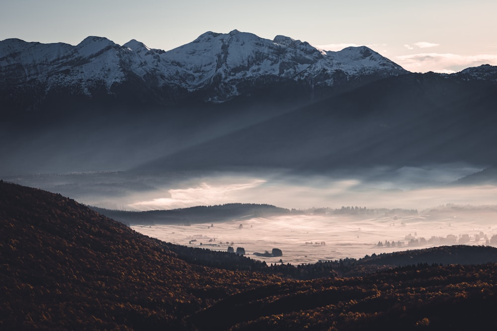 a view of a mountain range covered in fog