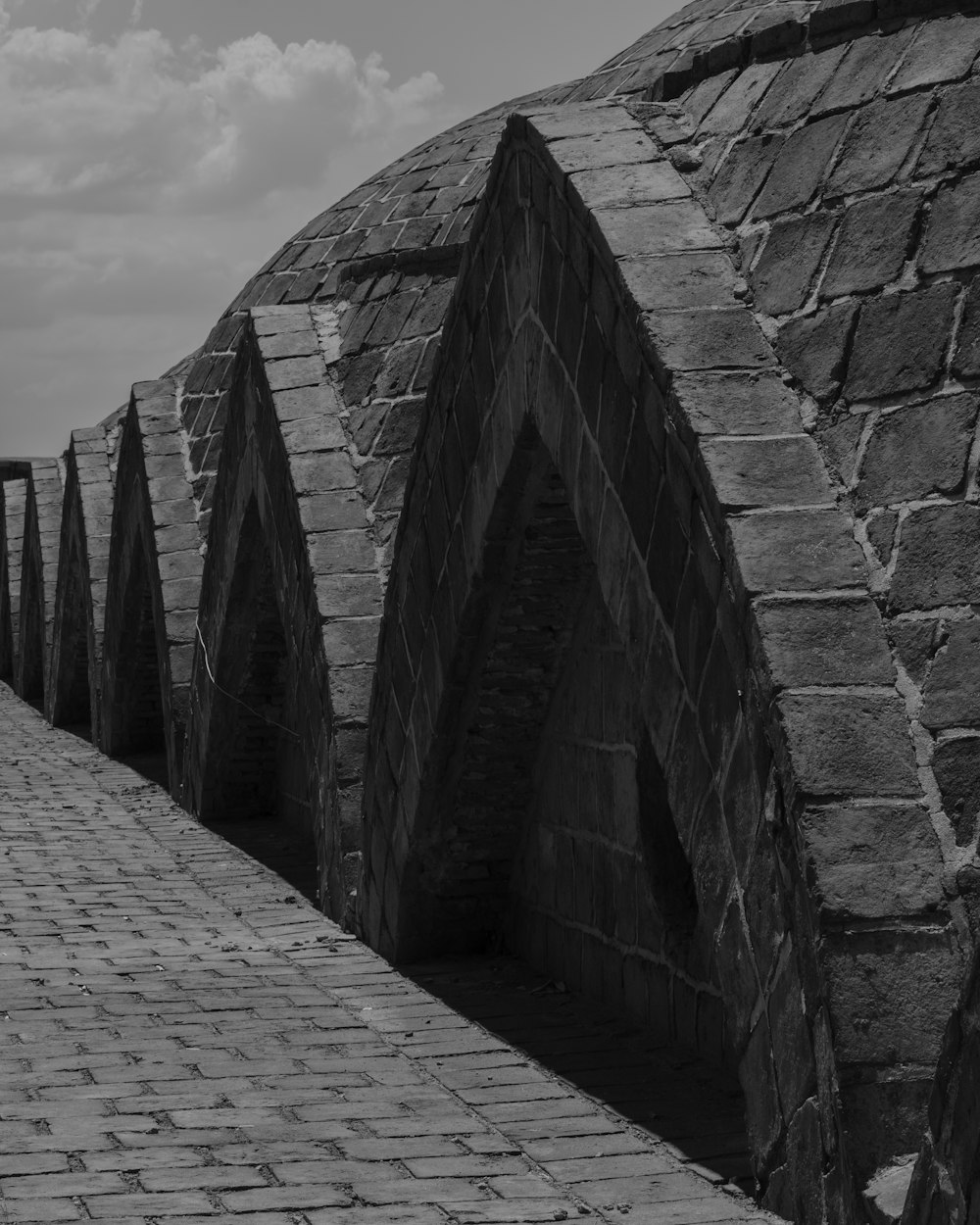 a black and white photo of a brick walkway