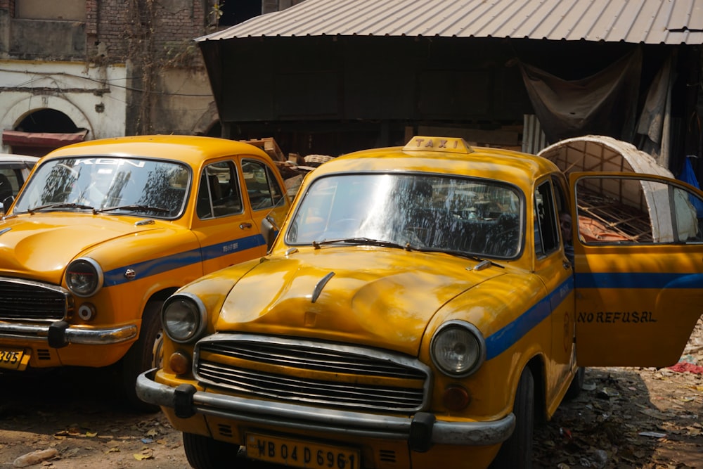 a couple of yellow taxi cabs parked next to each other