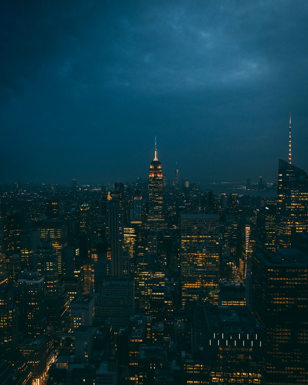 a view of a city at night from the top of a building