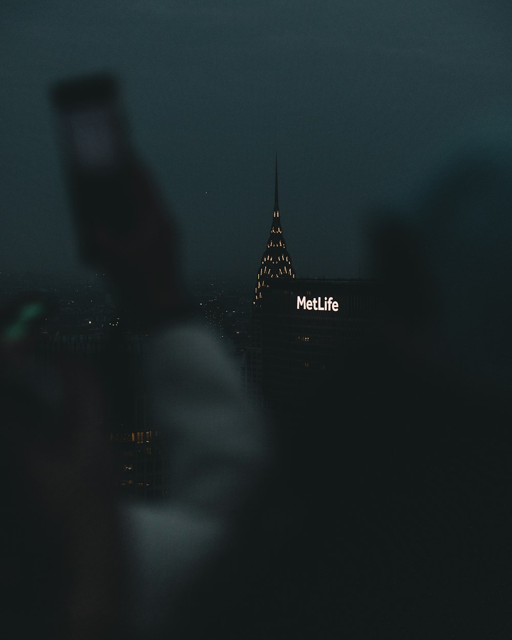 a person taking a picture of a building at night