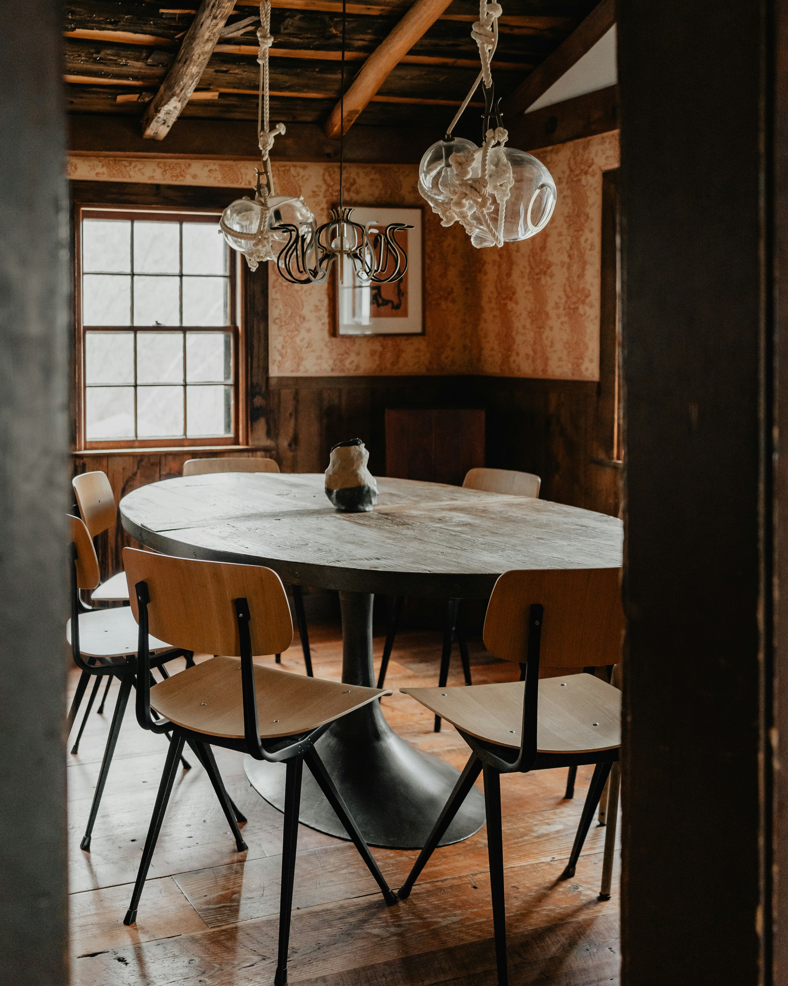 Dining room with oval table and modern chairs.