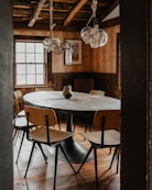 a dining room table with chairs and a chandelier