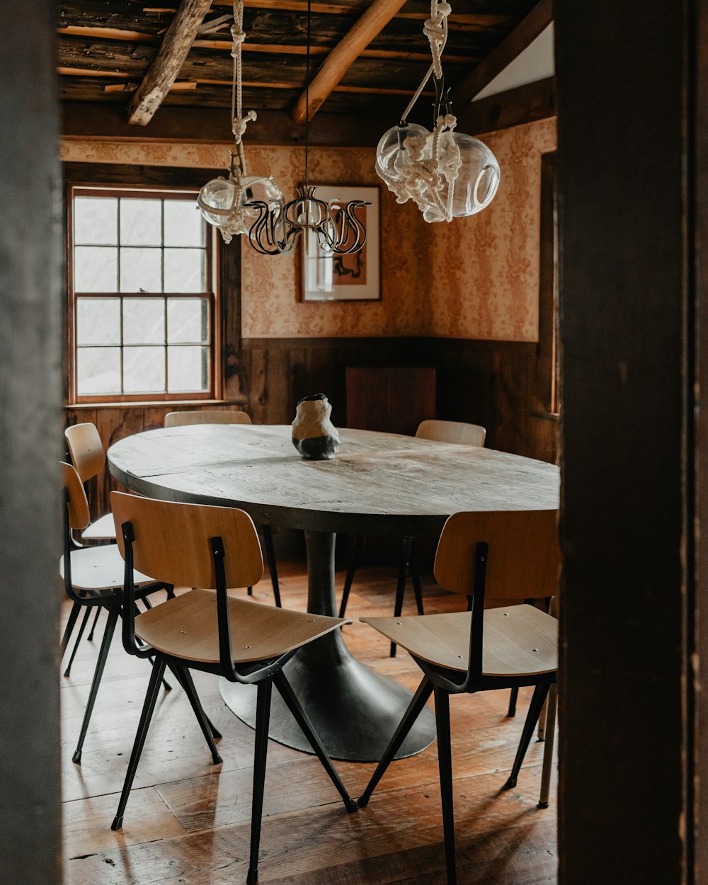 a dining room table with chairs and a chandelier