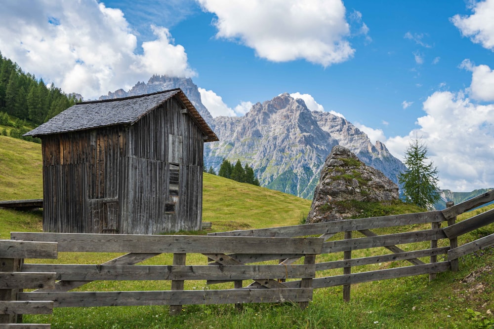 a wooden fence in front of a wooden building