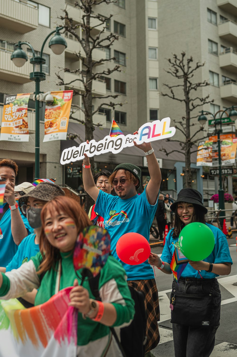 a group of people walking down a street holding signs