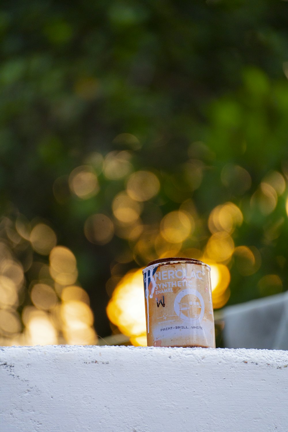 a cup of coffee sitting on top of a white wall