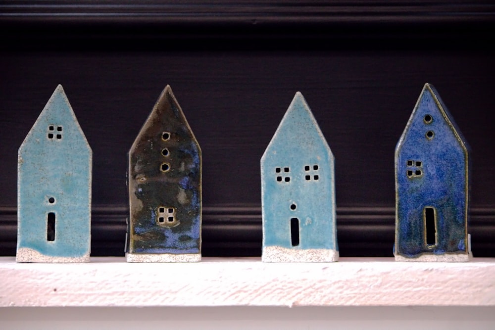 a row of small houses sitting on top of a shelf
