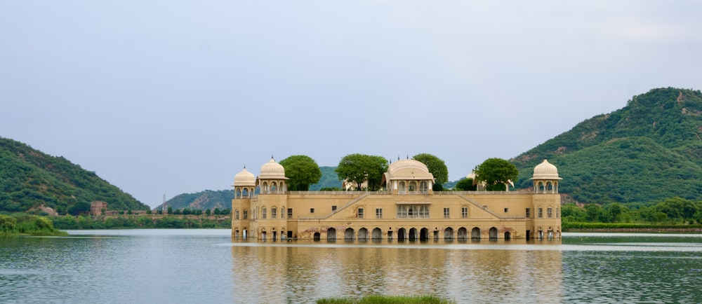 a large building sitting in the middle of a lake