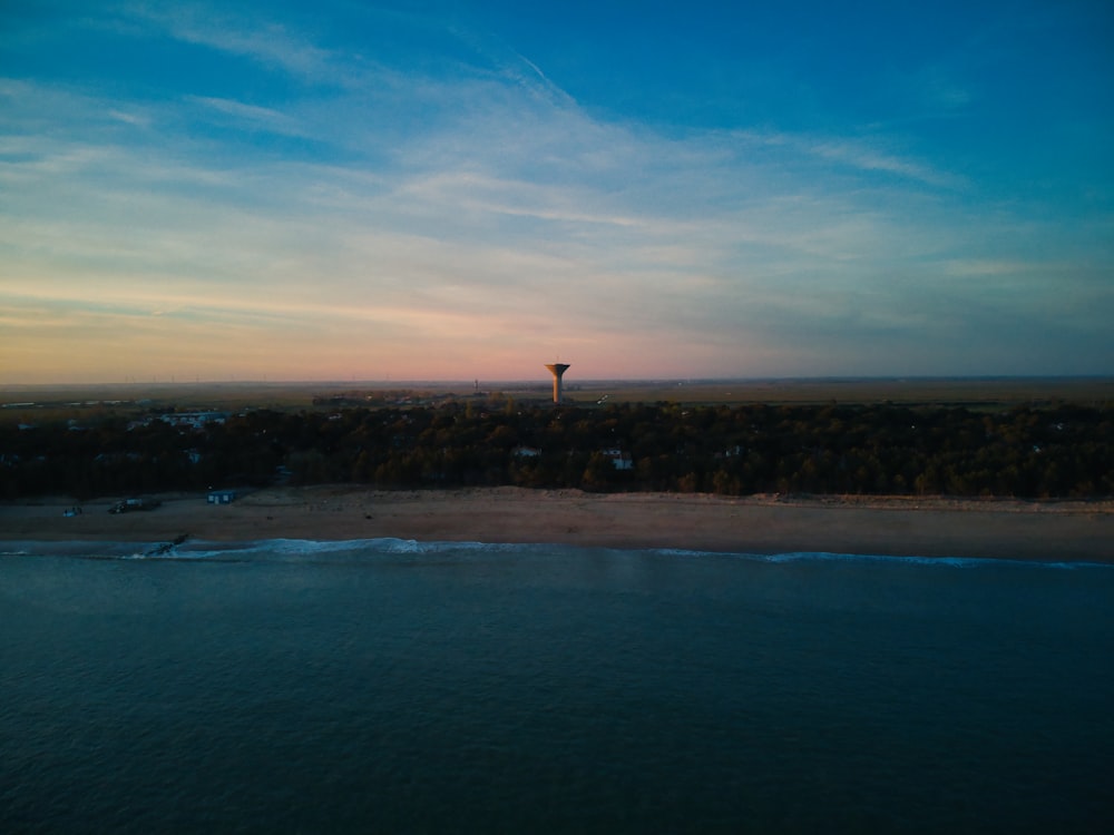 a hot air balloon flying over the ocean