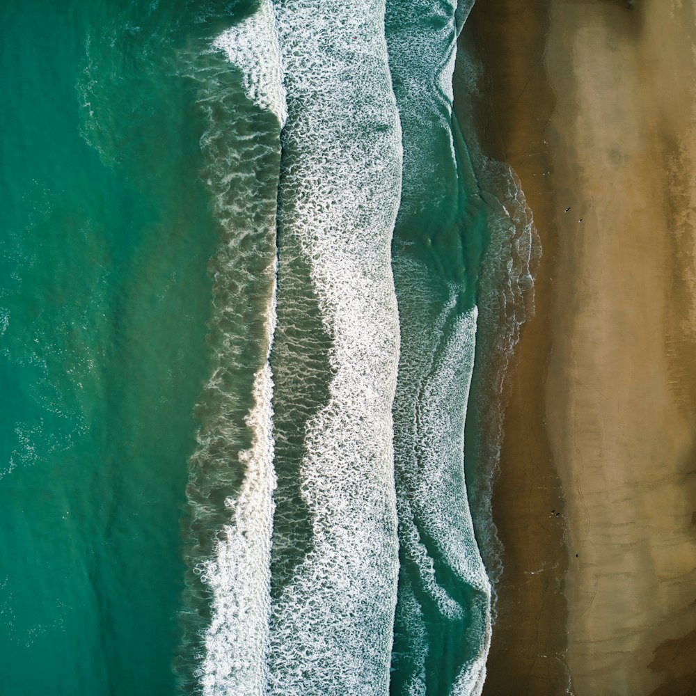 an aerial view of the ocean and the beach