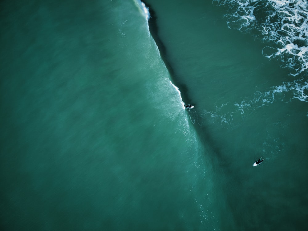 a person riding a surfboard on a wave in the ocean