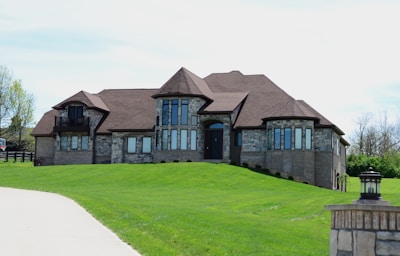 a large house sitting on top of a lush green field