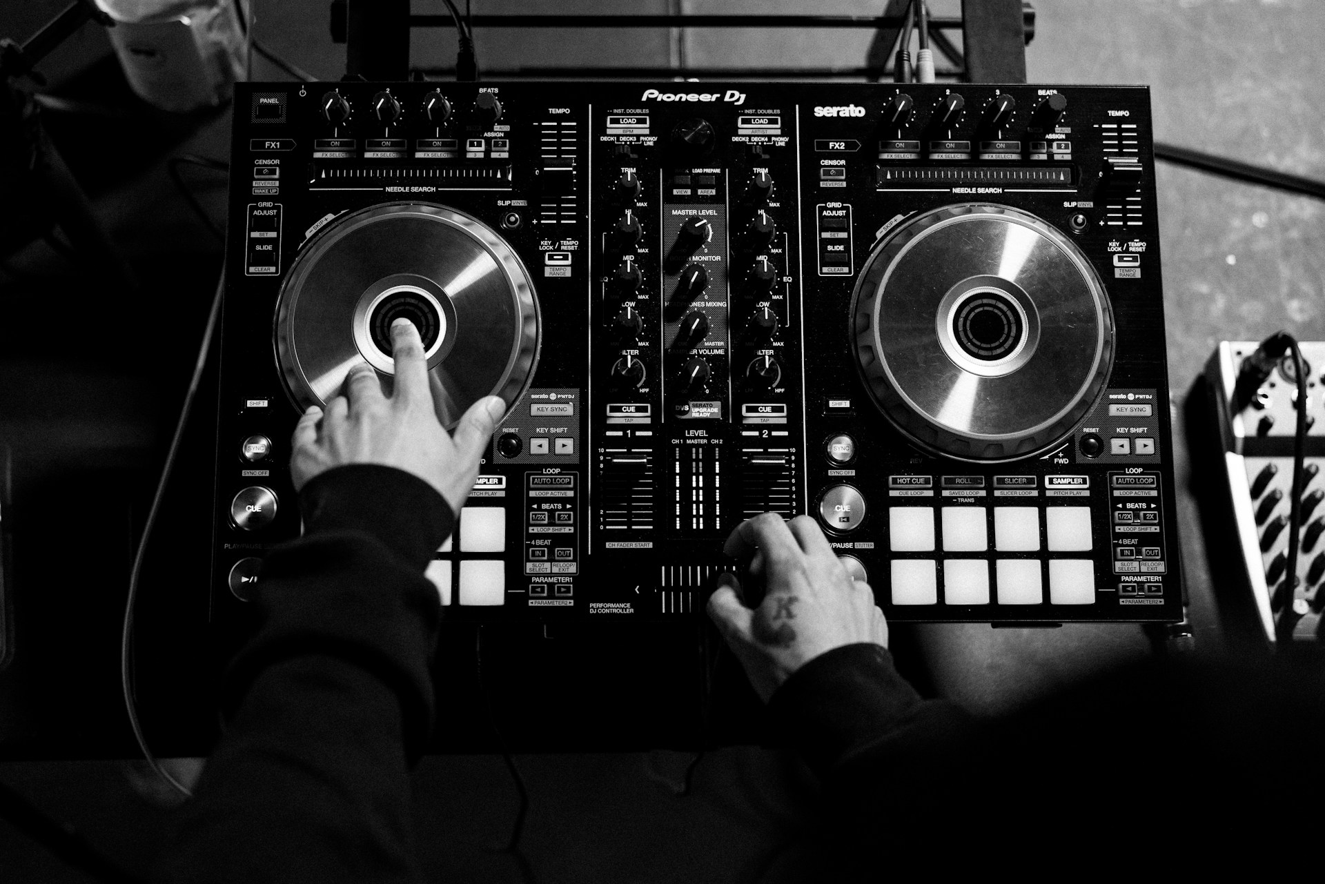 a person is playing a dj's turntable in a recording studio