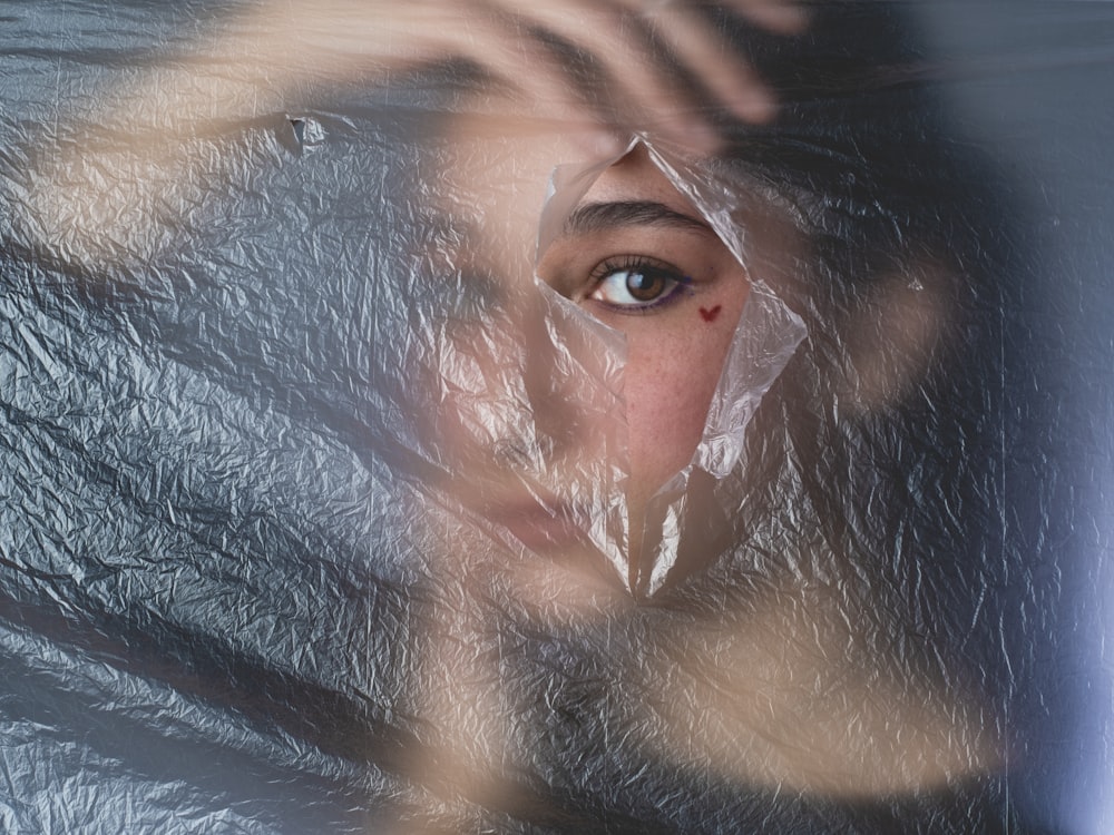 a woman's face is covered in plastic