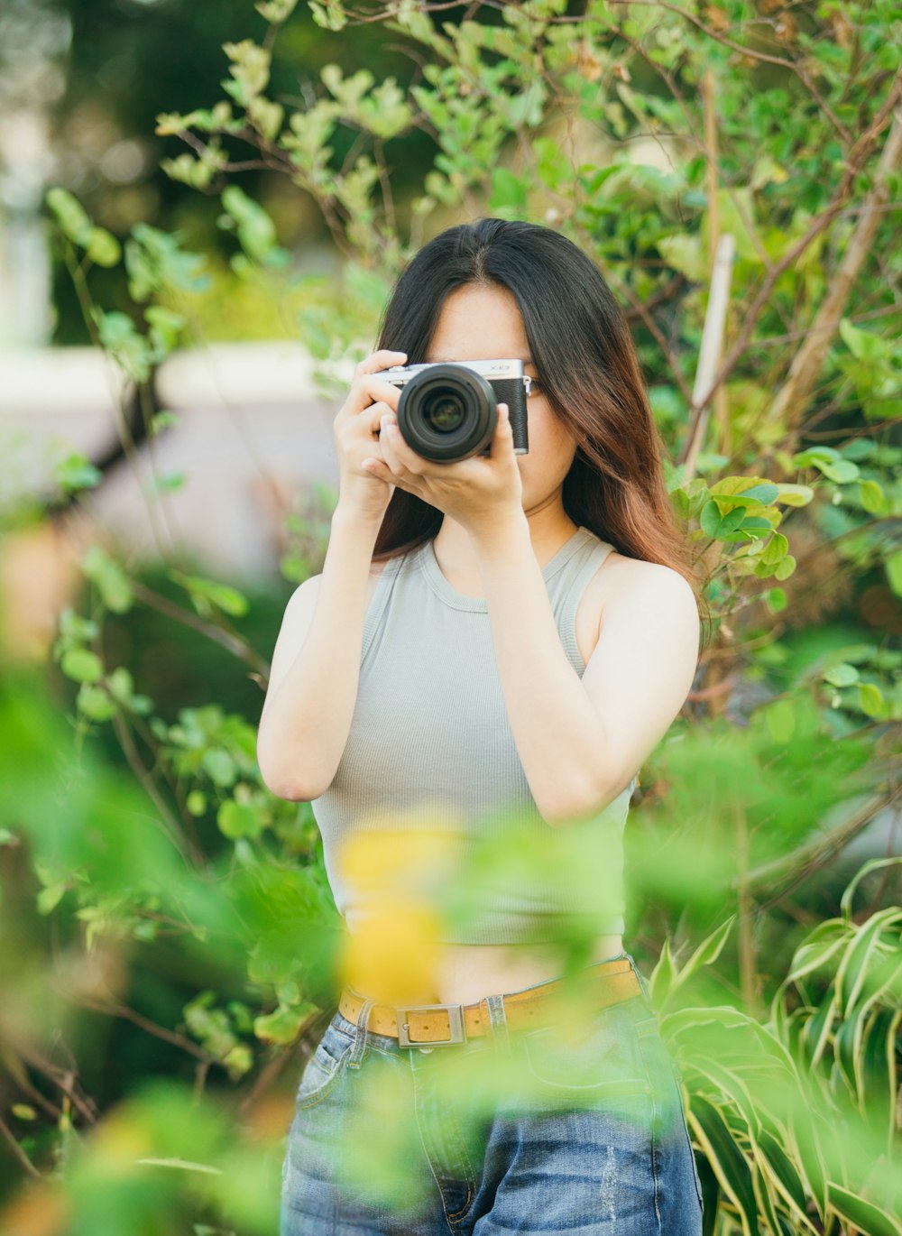 a woman taking a picture of herself with a camera