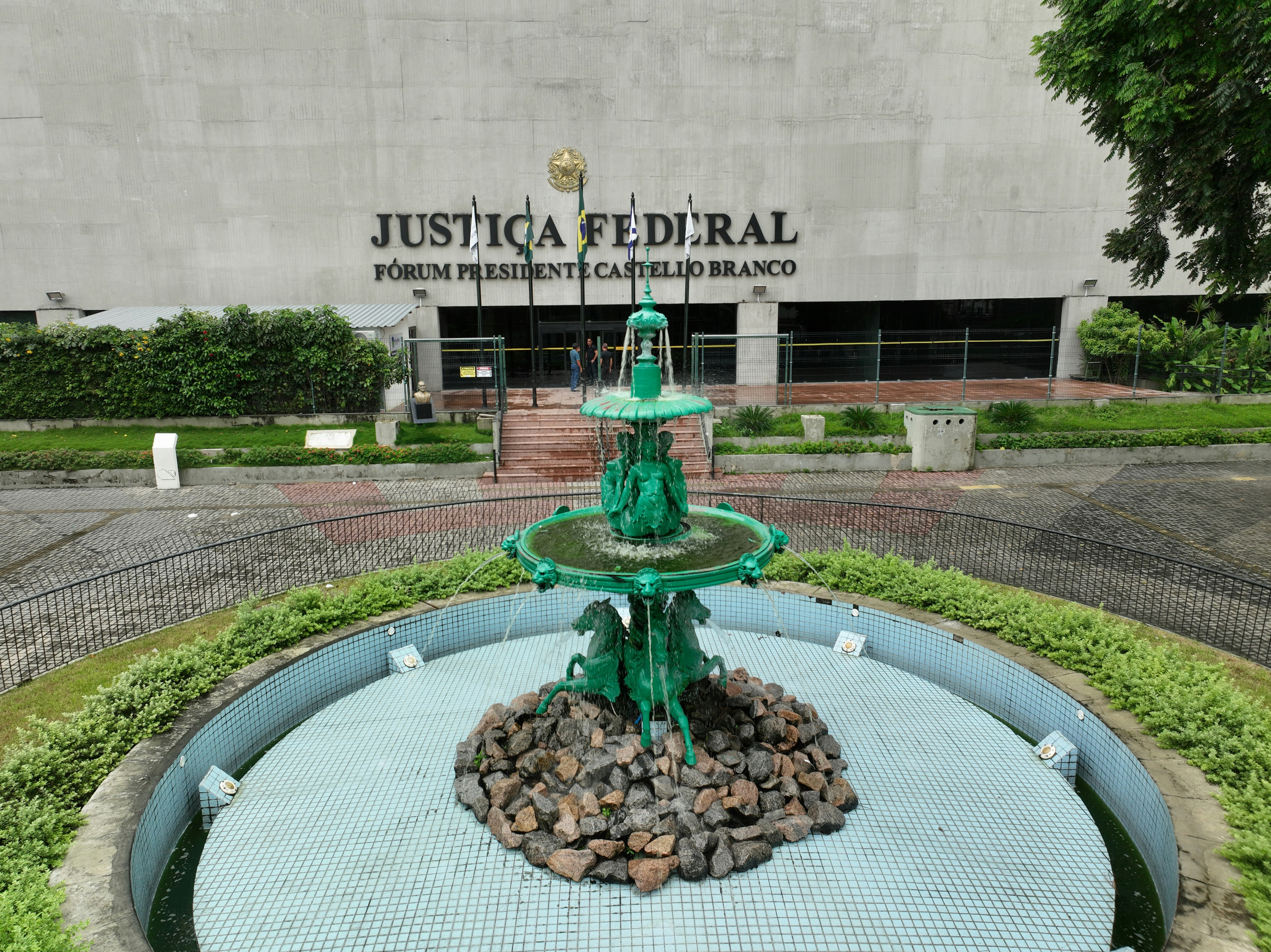 a green fountain in front of a building