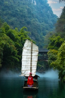 a person on a small boat in a river