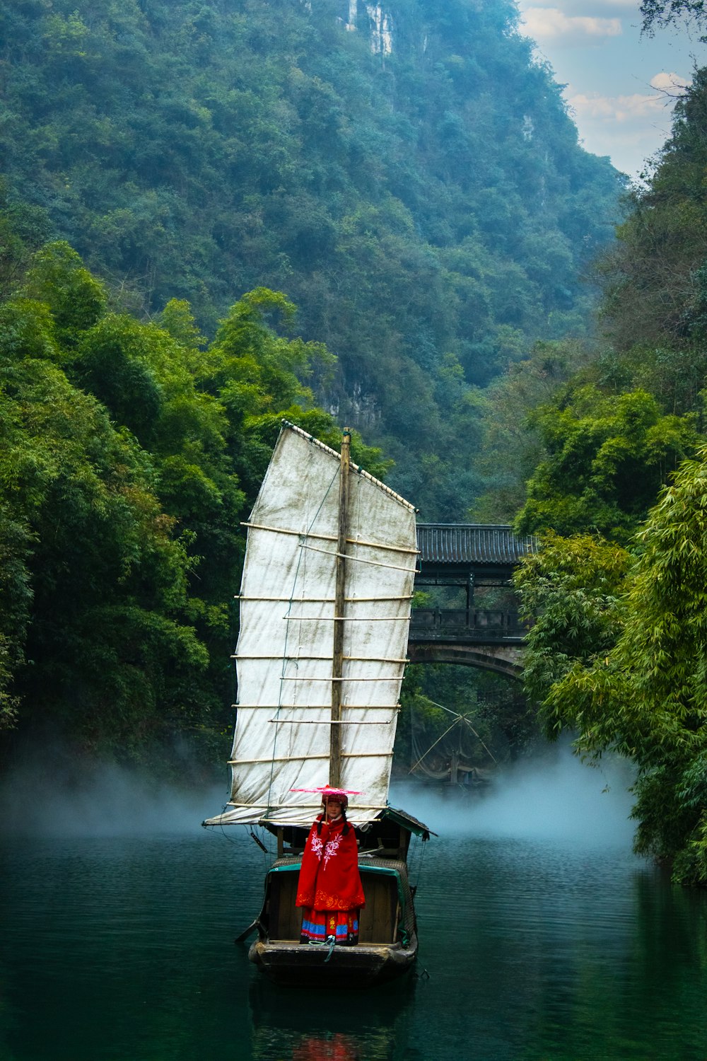 a person on a small boat in a river