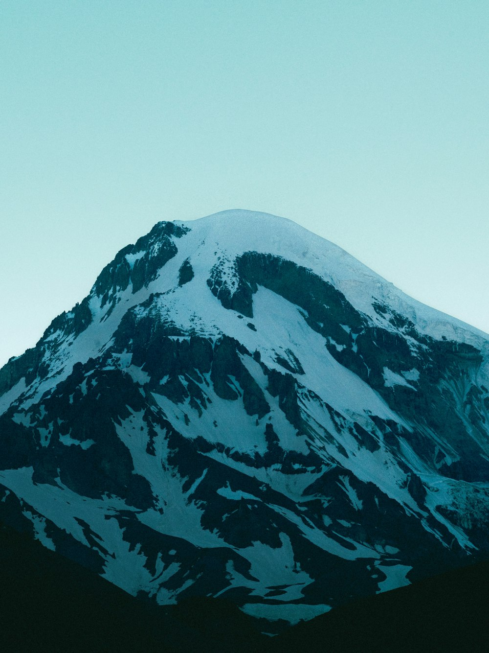 a snow covered mountain with a sky background