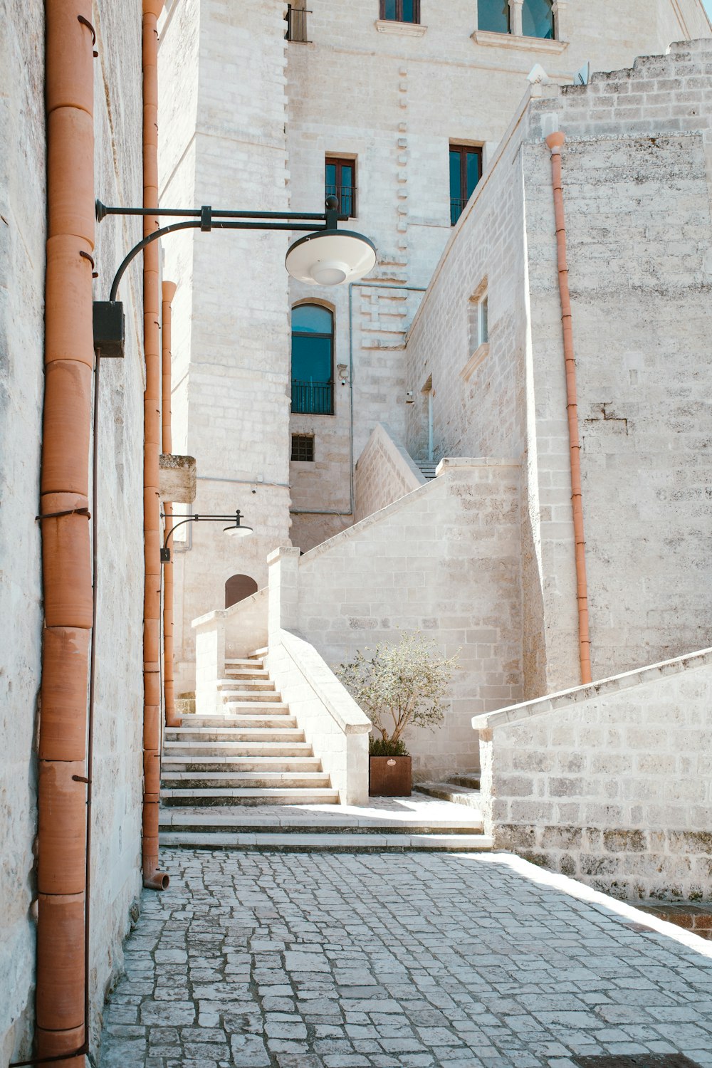 a street light on a brick sidewalk next to a building