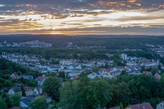 a view of a city with a sunset in the background
