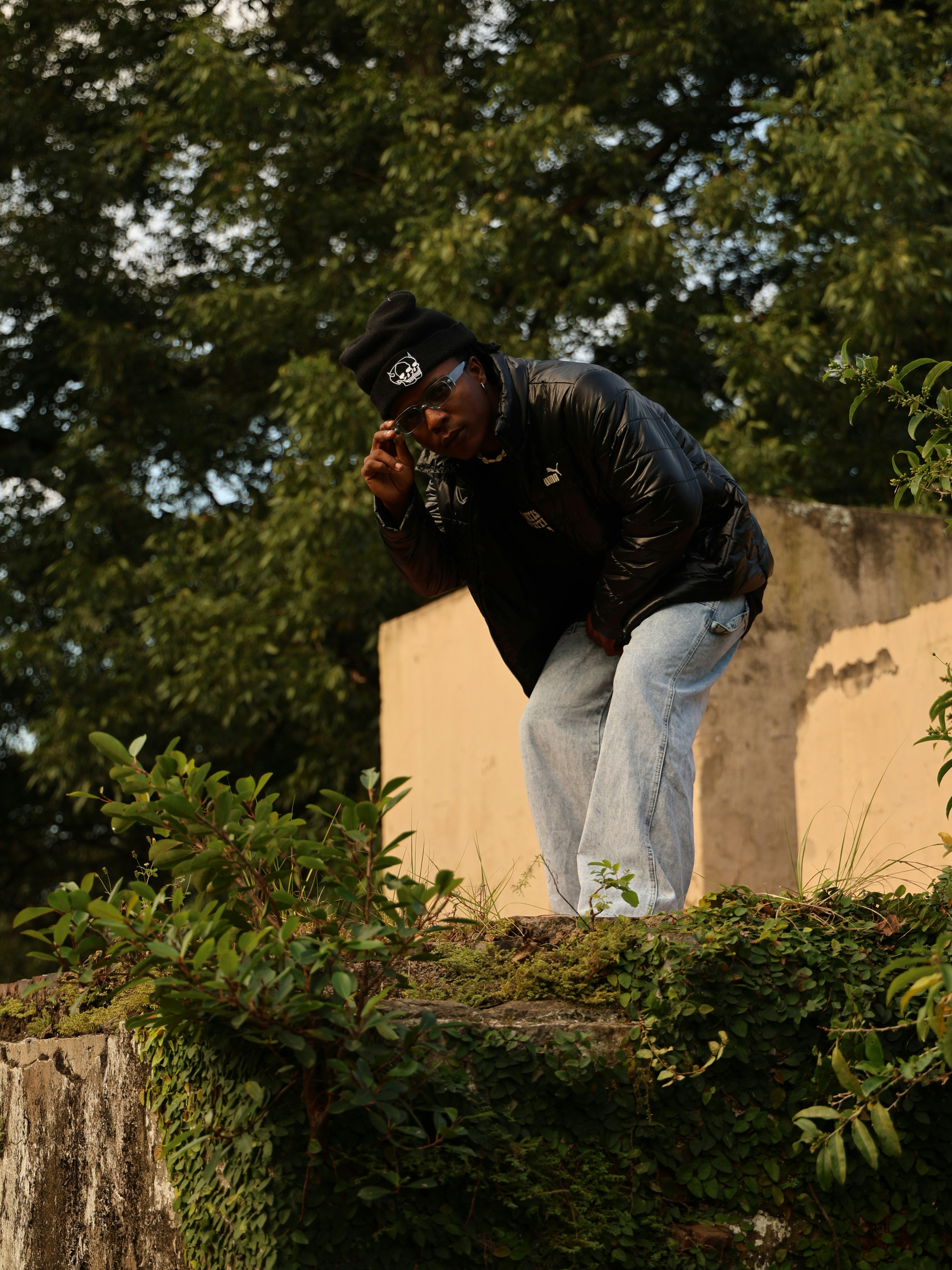 a man standing on top of a stone wall