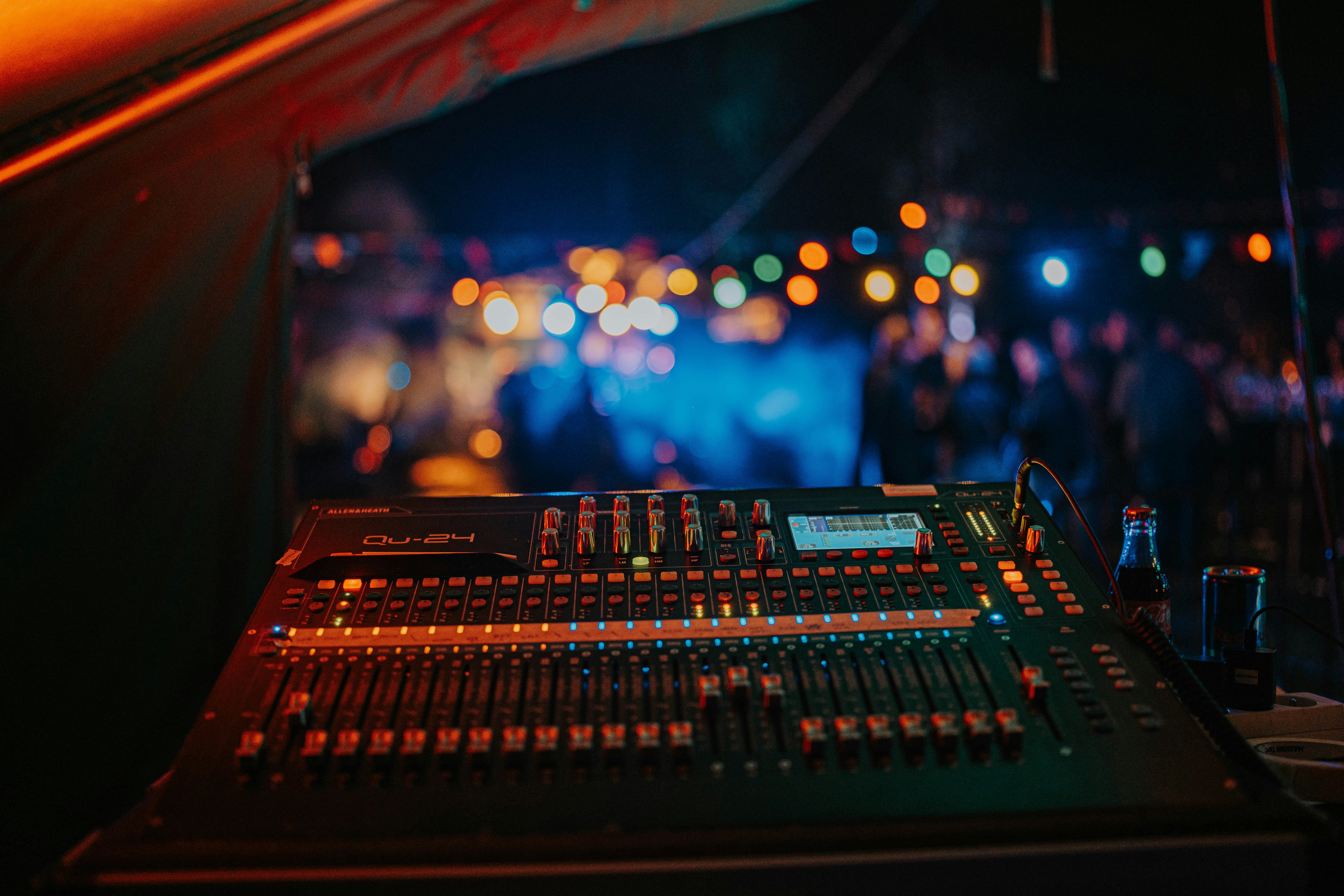 a sound mixing console in a dark room