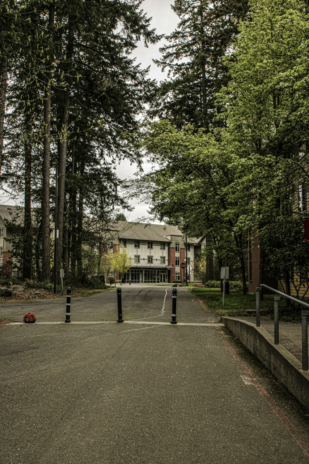 a street with a stop sign and a building in the background