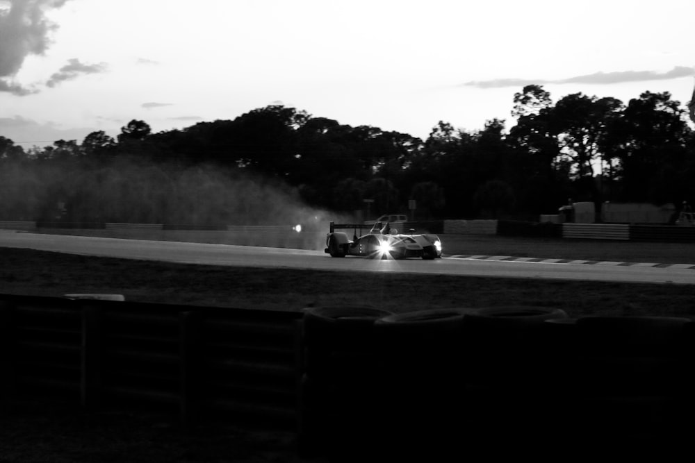 a car driving down a race track at night