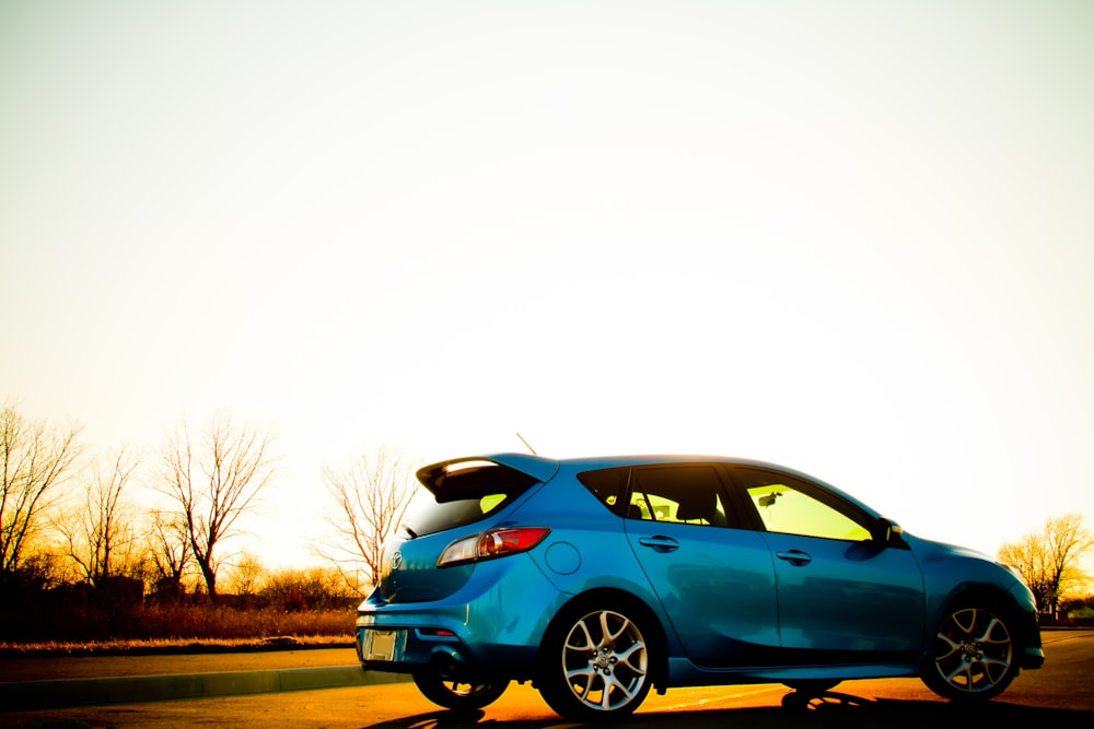 a blue car parked on the side of the road