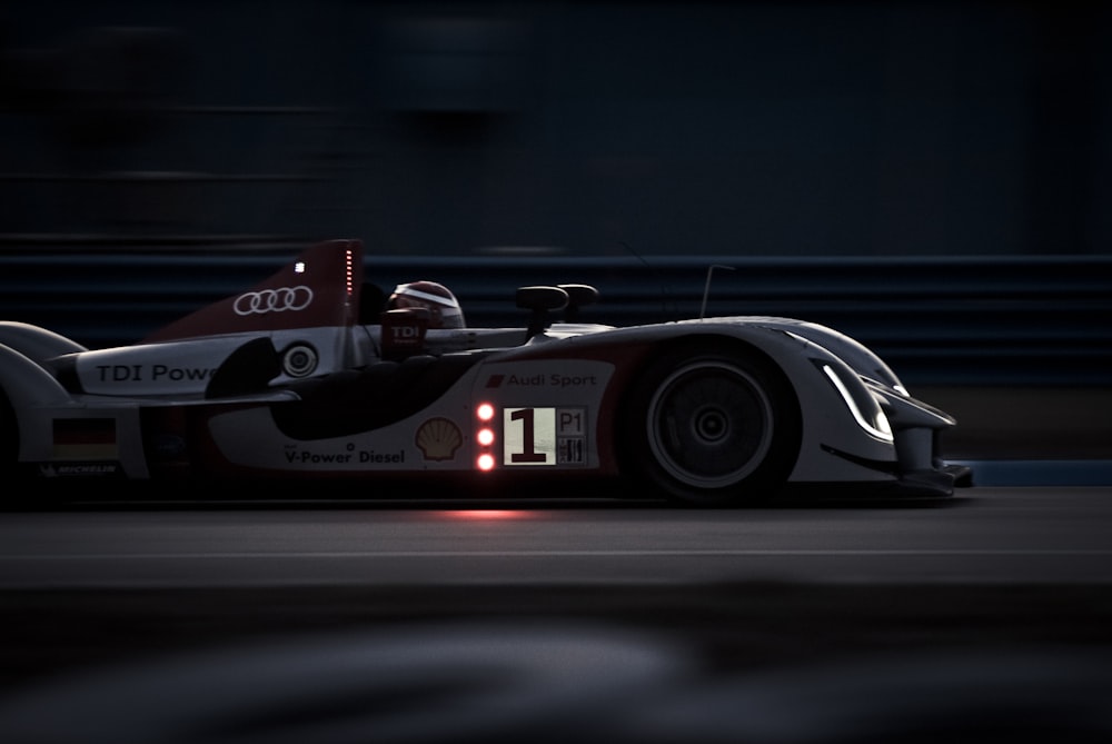 a race car driving on a track at night