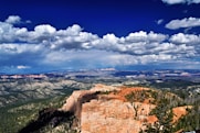 a scenic view of a mountain range with clouds in the sky