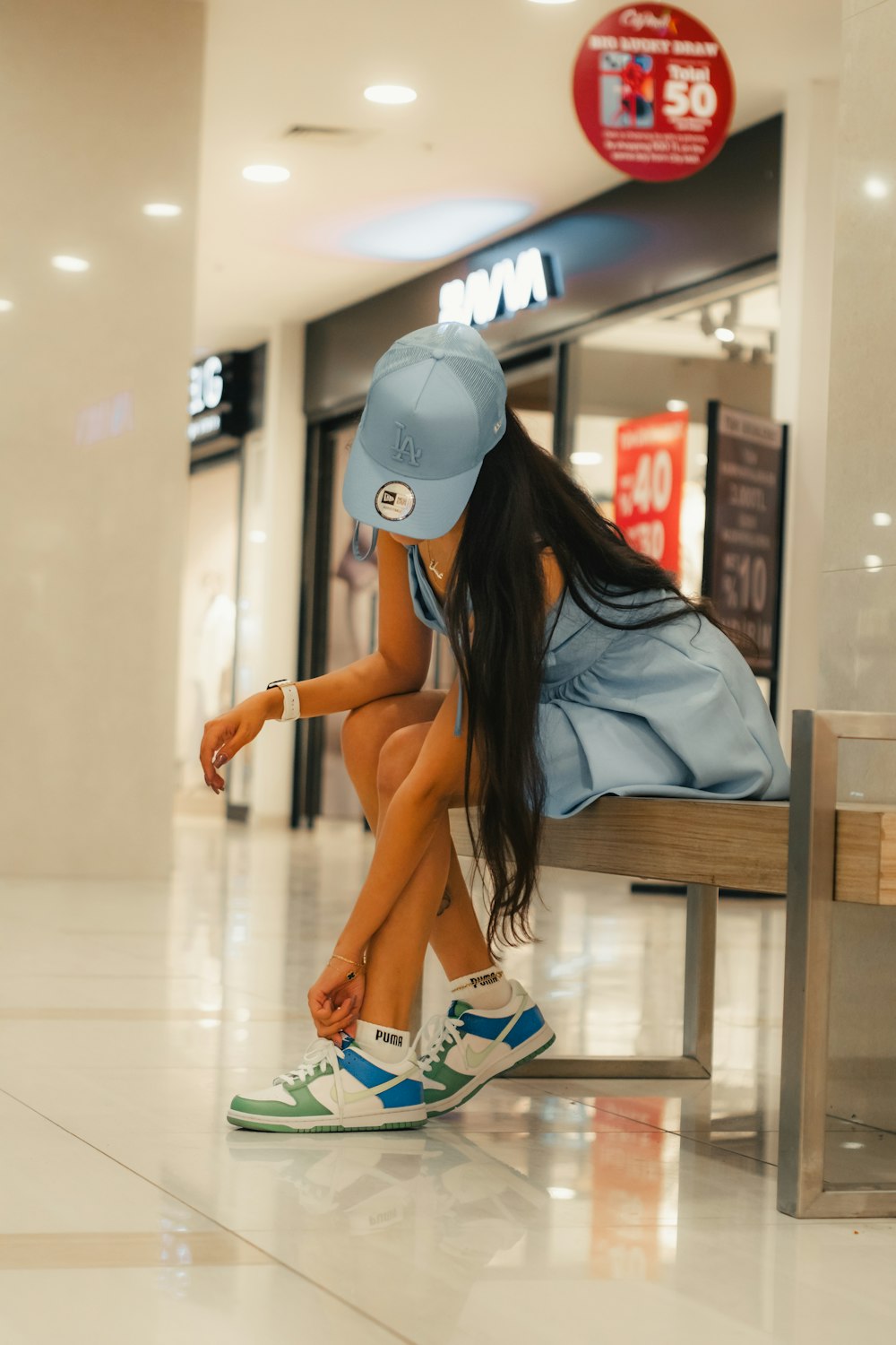 a woman sitting on a bench in a mall