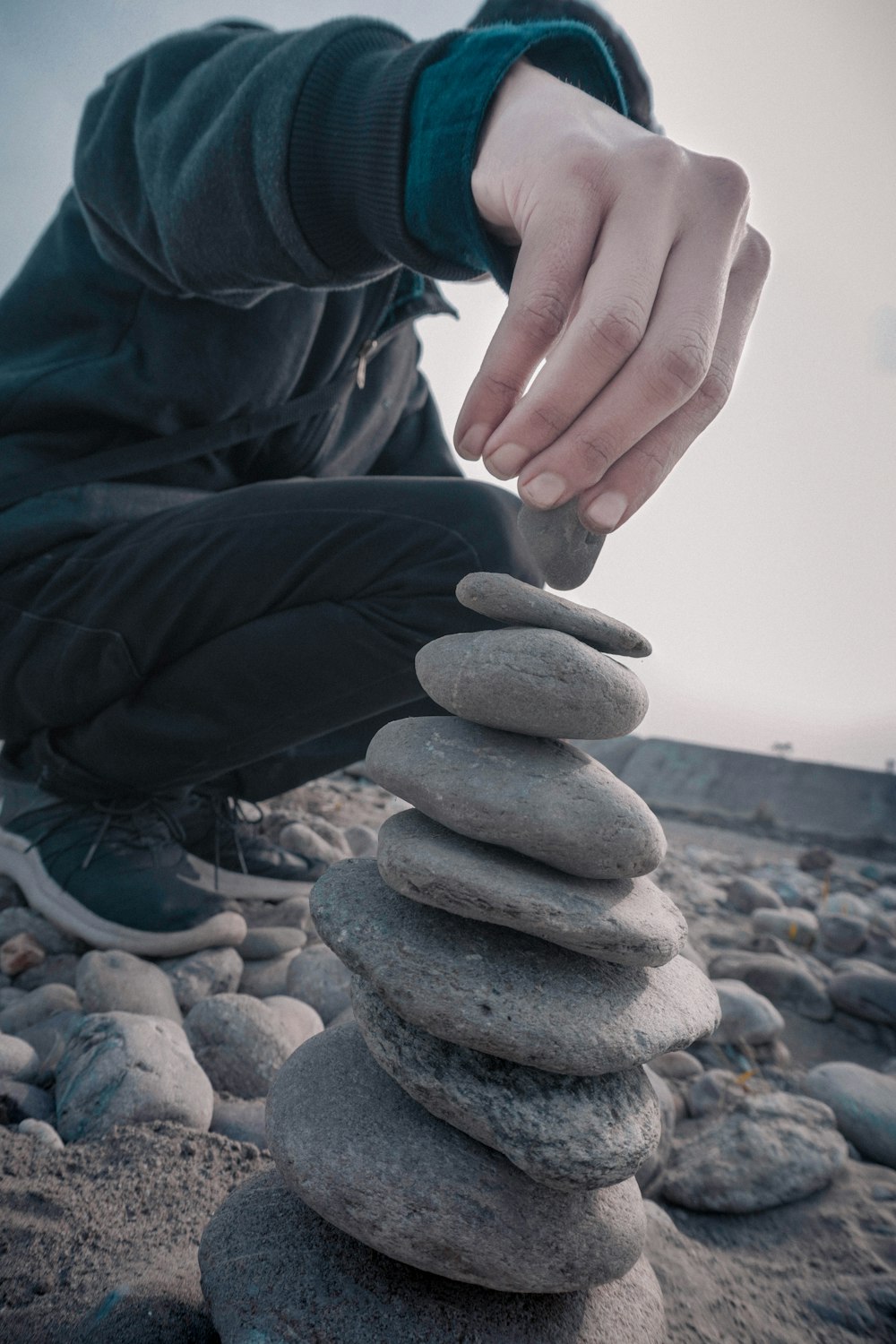 a person stacking rocks on top of each other