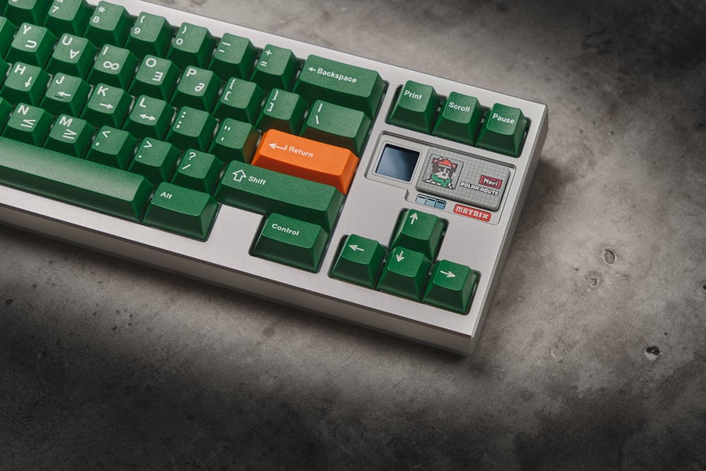 a green and white keyboard sitting on top of a table