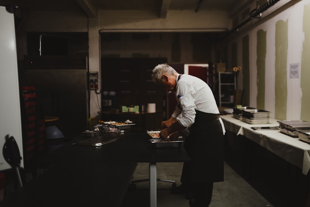 a man standing in a kitchen preparing food