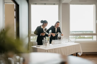 a couple of women standing next to each other at a table