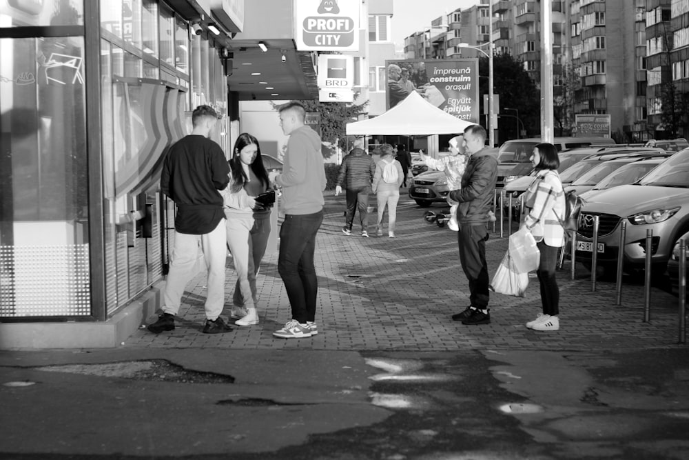 a group of people standing outside of a store