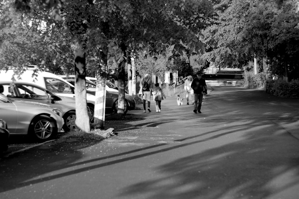 a black and white photo of people walking down a street