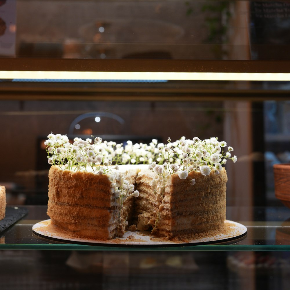 a cake with white flowers on top of it