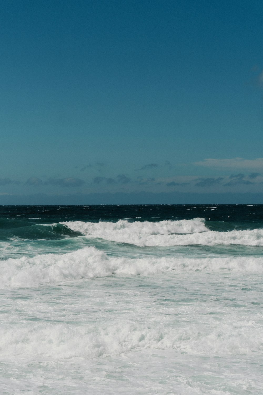 a man riding a surfboard on top of a wave in the ocean