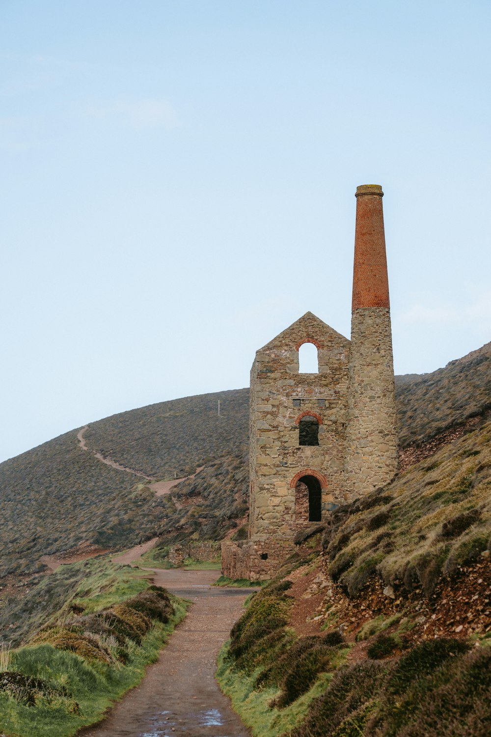 a stone building sitting on the side of a hill